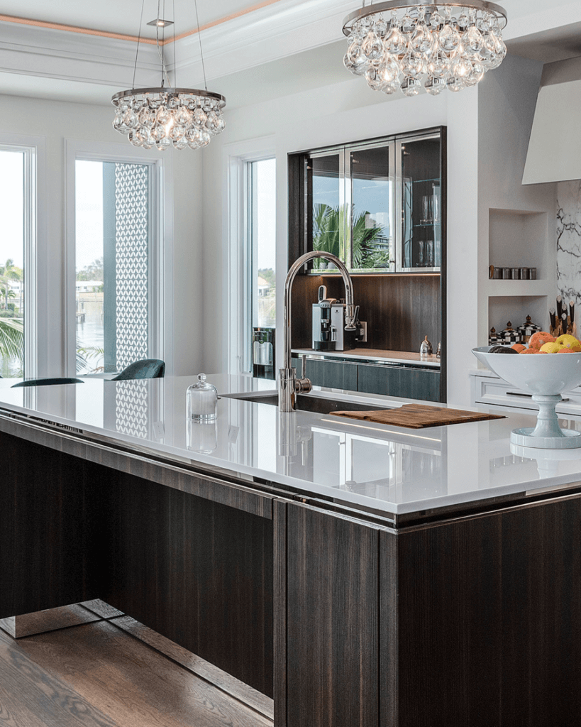Luxury kitchen island sink with elegant chandeliers above