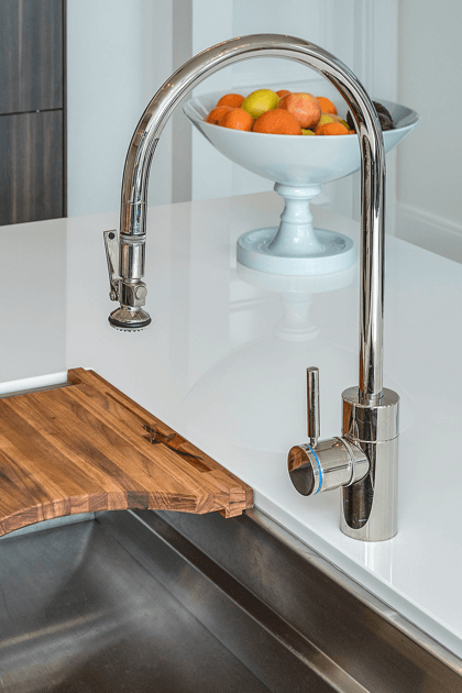 Closeup of silver pulldown sprayer faucet in kitchen