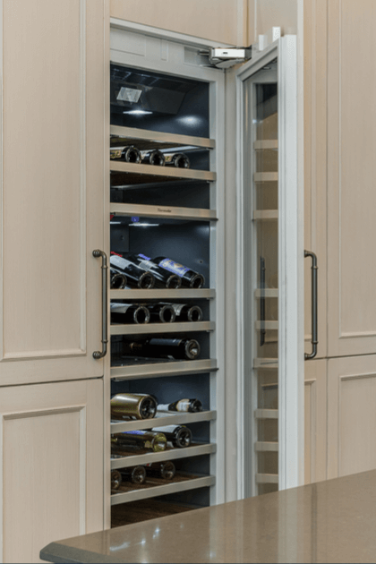 Built-in wine cooler with racks of wine bottles