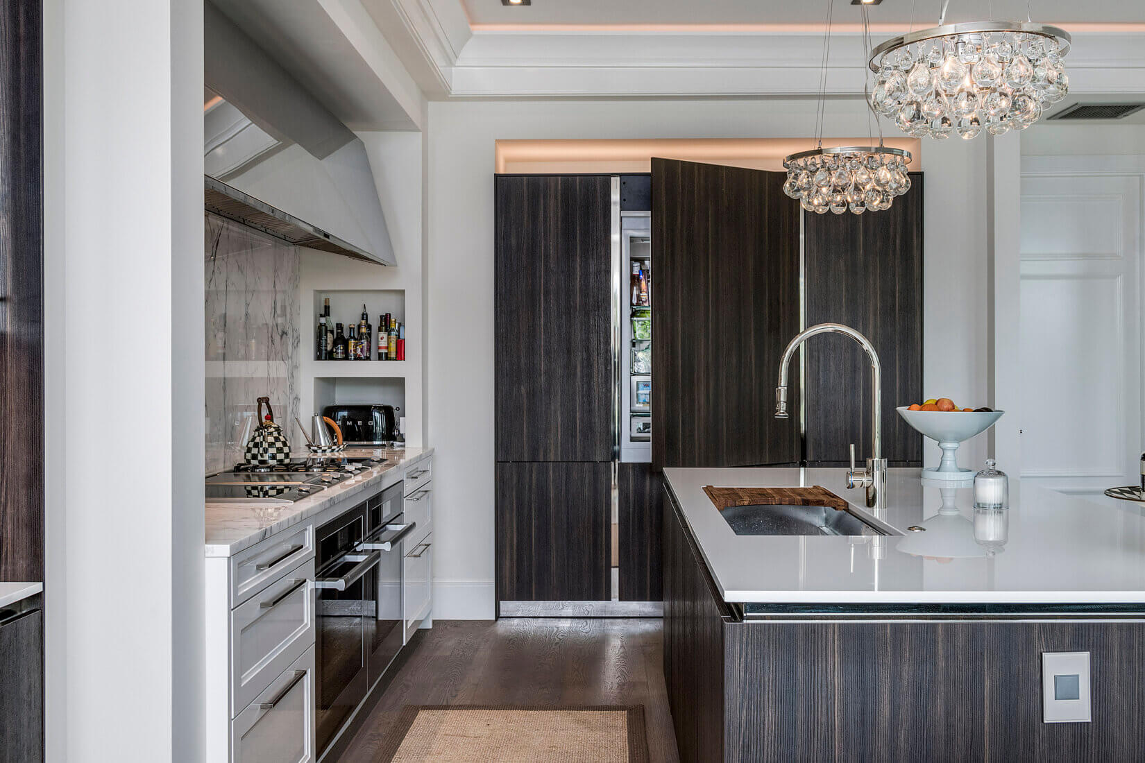 Luxury kitchen with dark-wood cabinetry and built-in refrigerator