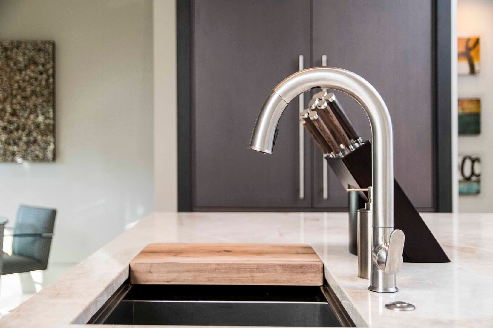 Closeup of silver pullout kitchen faucet in luxury kitchen
