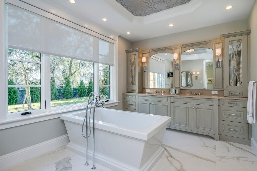 Luxury bathroom with white tub and big windows