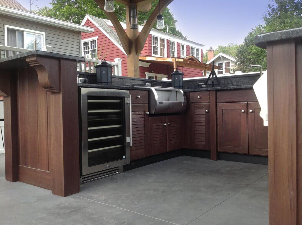 Dark wood-finished outdoor kitchen with upscale appliances
