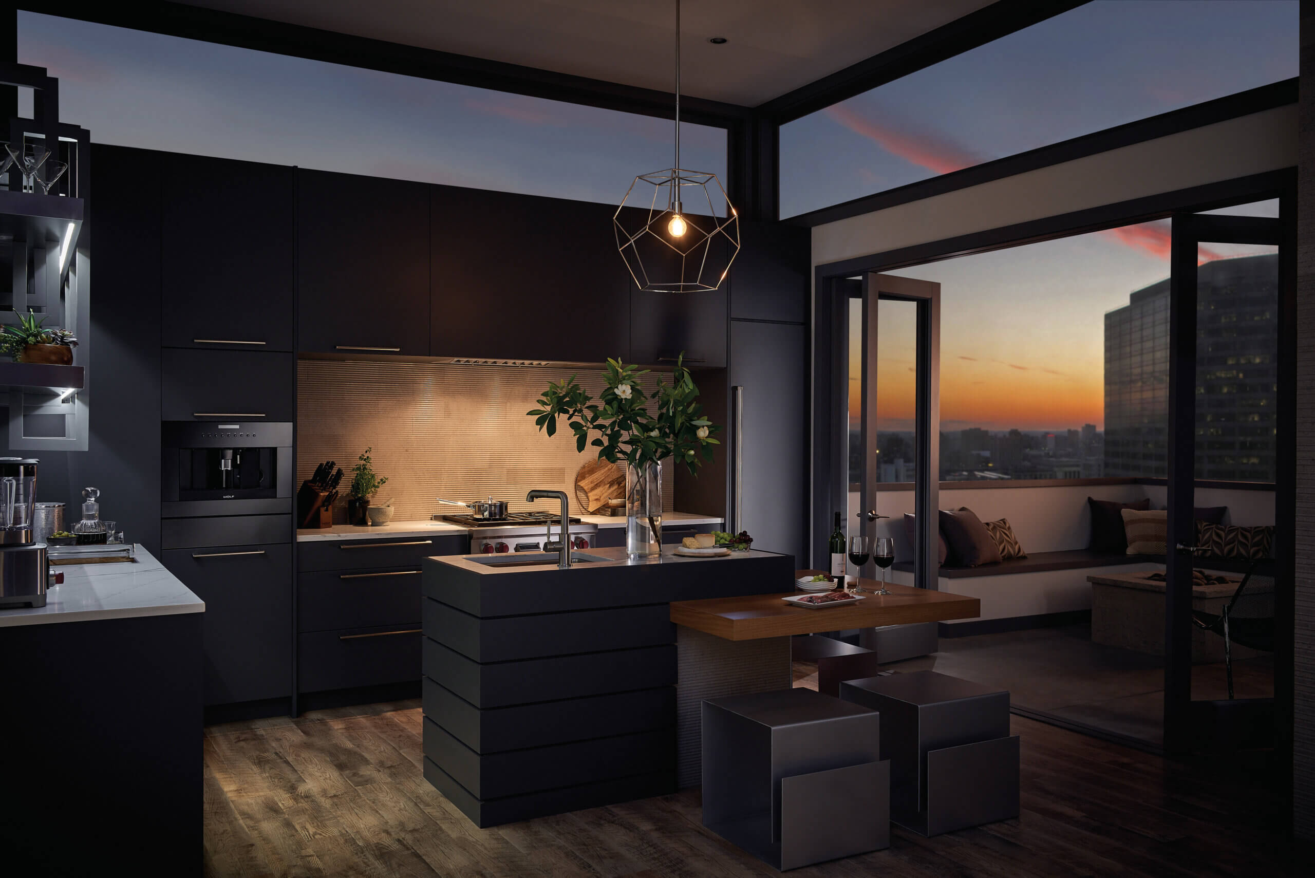 Modern kitchen design with black cabinetry and sunset on balcony in background