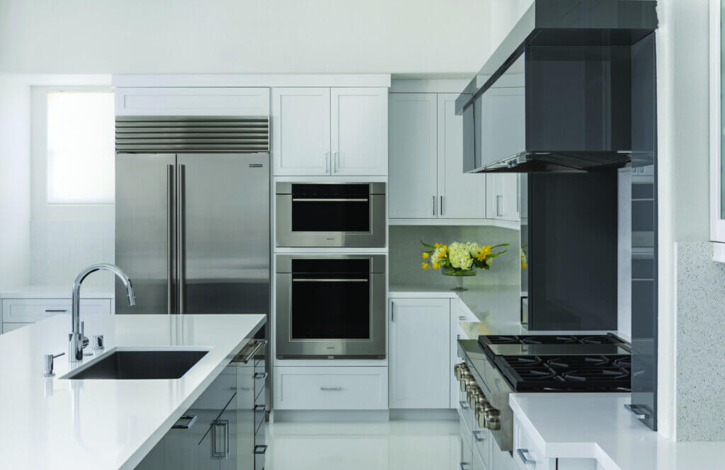 Modern white kitchen design with stainless steel appliances