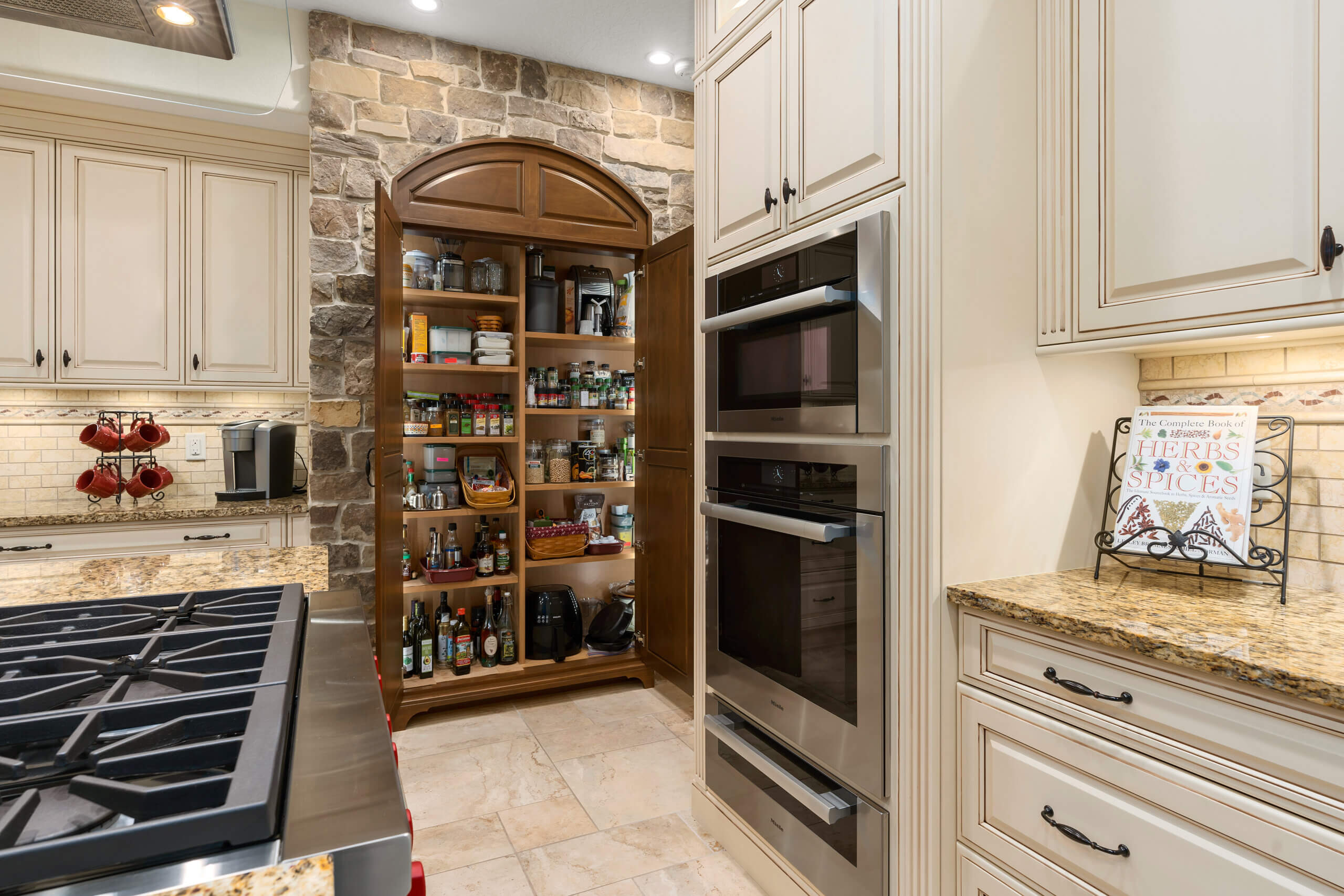 Luxury kitchen with large built-in pantry and upscale appliances