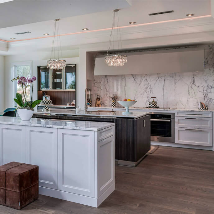 Luxury kitchen with marble countertops, pendent lights and high-end appliances